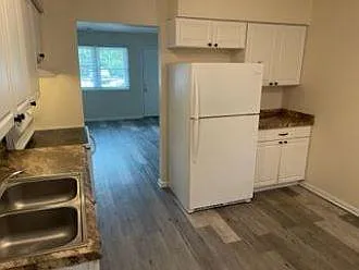 Kitchen view to living room and front door.