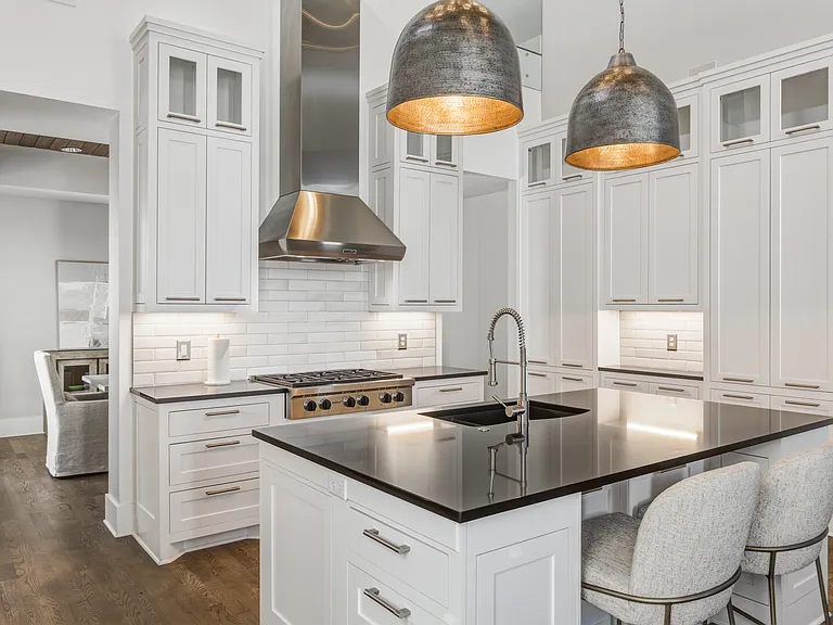 The chef's kitchen boasts a massive island, pantry wall, Wolf steam & convection ovens, a 6-burner 36" gas range and Sub-Zero refrigerator. Everything you need to cook at home, plus island seating and a dining table/room.