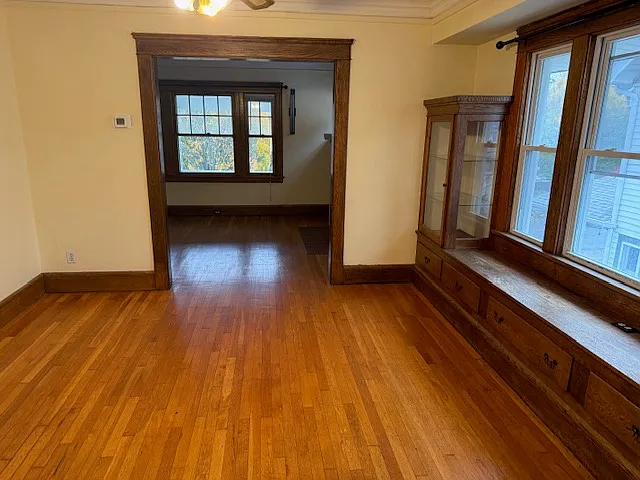 Hardwood Floor and China cabinets in dinning room. Bench window