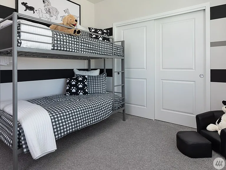 Spacious room with a large closet, soft carpeting, and plenty of natural light - perfect for a bedroom, home office, or flex space.