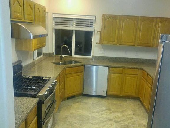 Kitchen with granite countertops and tiled floors
