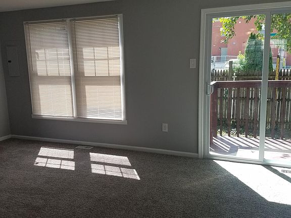 Living room out to private fenced in yard.
