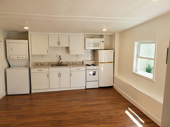 Open kitchen with washer and dryer