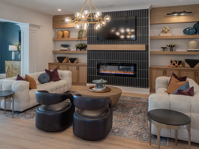 Clubhouse living room with ample seating, fireplace and TV.