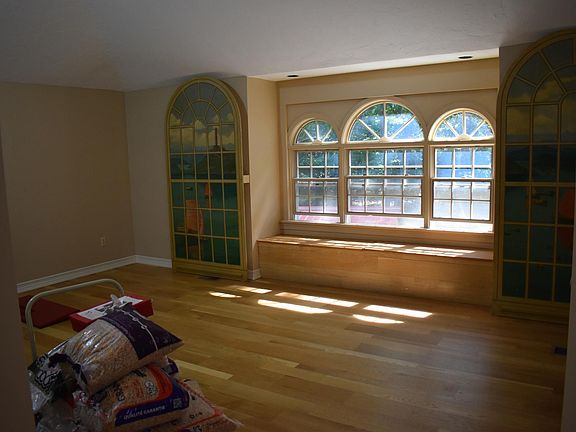 Living area with large windows, skylights, and newly refinished hardwood floors