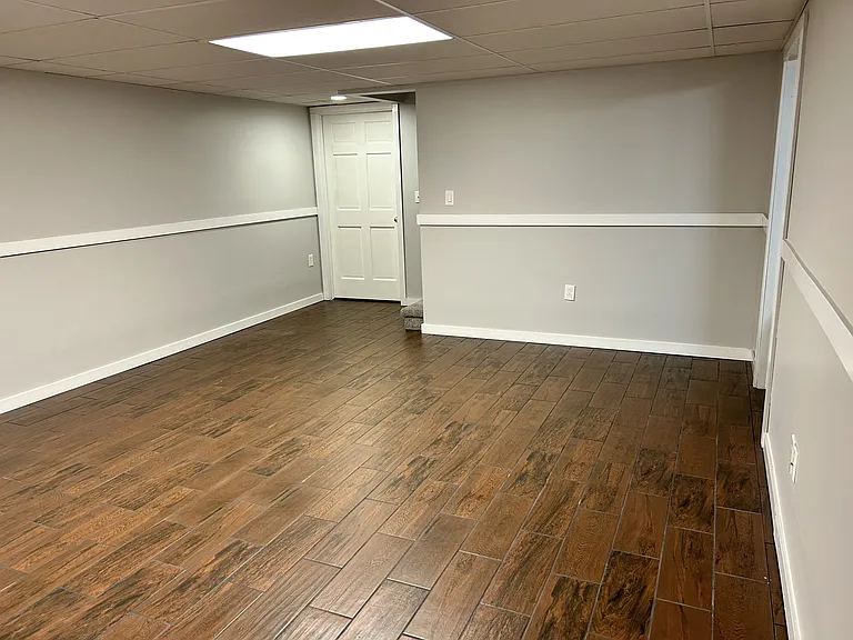 Basement main room (there is an unfinished room in back with water heater & furnace and additional storage)