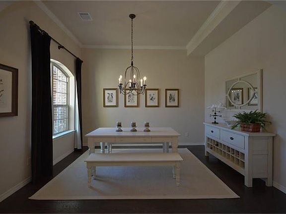 The stunning formal dining room features wood floors, crown molding, and high ceilings.