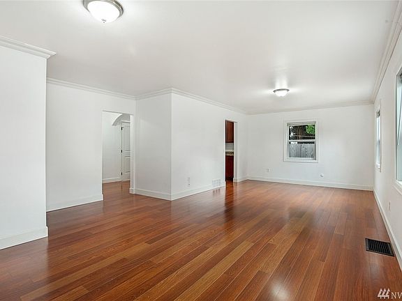 Can you say open space?? No small choppy rooms here. Looking into Family Room from front entry. Beautiful laminate hardwood, updated lighting. Oh and bright white fresh interior paint throughout. Clean pallet to create your own Picasso Masterpiece.