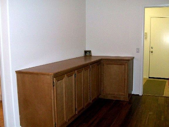 Hall with Walnut Floors and Linen Storage
