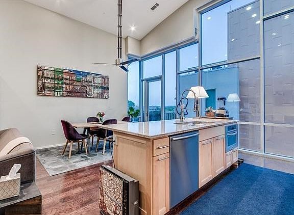 Kitchen island is home to built-in microwave and dishwasher.