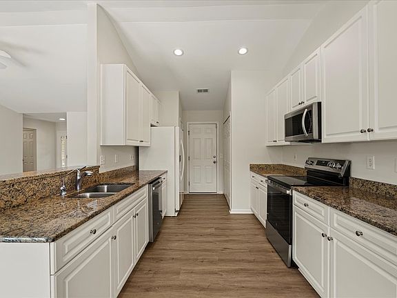 Kitchen with white cabinets and granite countertops at 16 Hawthorne Ct