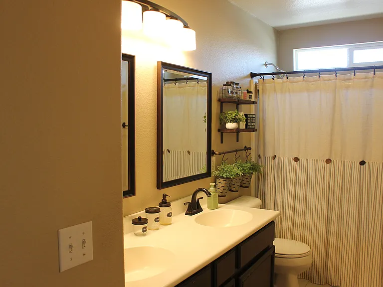 Bathroom with dual sinks and shower-tub combo