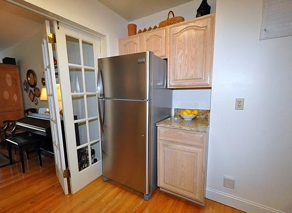 New Eat-in-Kitchen with Granite Counters and Stainless Steel Appliances including a dishwasher, range and refrigerator.