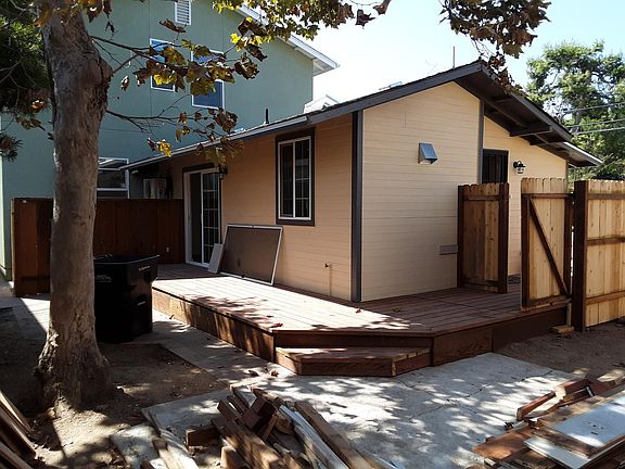 Rear yard of companion unit. Separate from main house with gate and fence. Fully accessible from Companion unit and front street yard. Raised deck around back and side of Companion unit. With separate gates to front street.