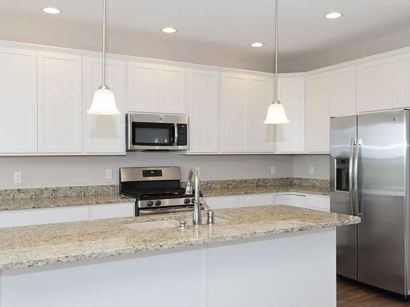 Bright kitchen with white cabinets and granite countertops