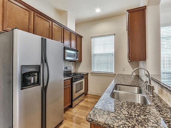 Kitchen features granite counter tops and desirable gas range.