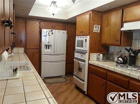 Updated kitchen boasts custom tile and lighting, new dishwasher and newer built-ins and flooring.