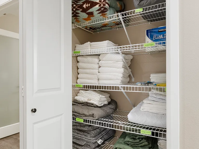 Upstairs linen closet with extra linens for each bed, blankets, and towels