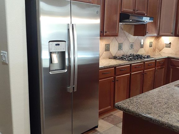 Gas Stovetop and NEW GE Refrigerator. Granite countertops.