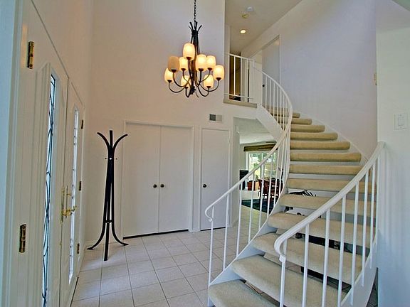 Foyer with Cathedral Ceilings & Spiral Staircase