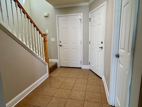 Entryway with laundry/half bath and door to garage.