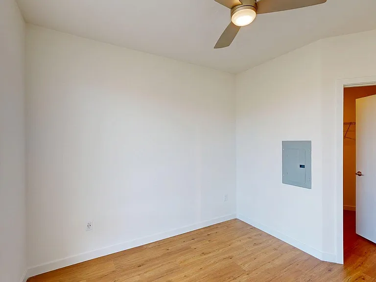 Spacious apartment Bedroom with Wood-Style Flooring.