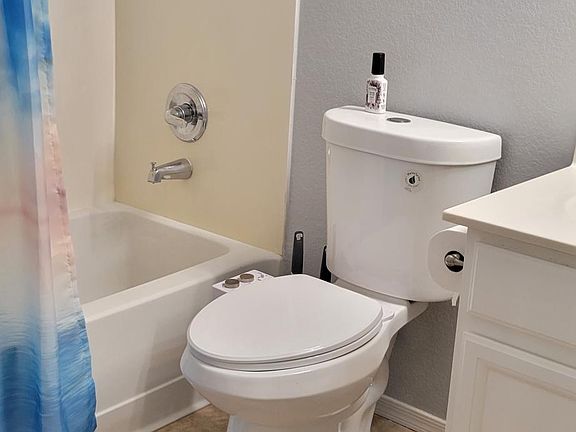Guest bathroom with shower tub combo. Also services two bedrooms.
