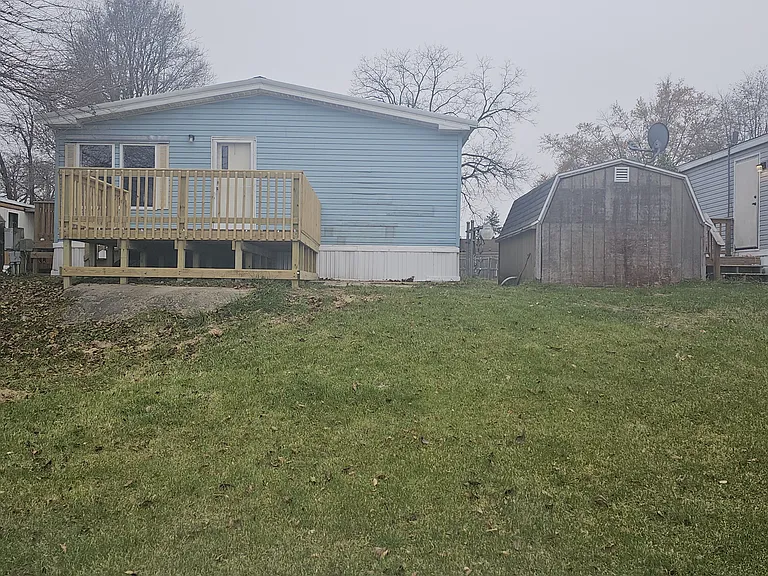 Exterior of backside of home. Very large backyard, brand new large deck off of backdoor, large shed with electricity for additional storage.