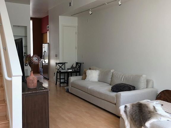 Living room looking in opposite direction from previous photo. Dining/Kitchen towards back of photo. (Furniture not included)