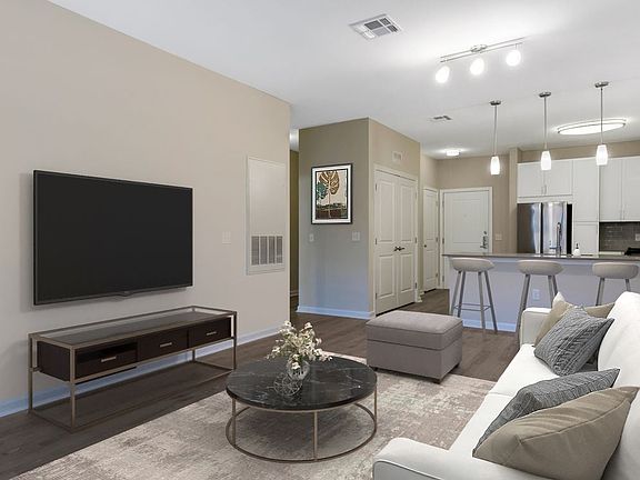 Renovated Package II kitchen, dining, and living areas with hard surface flooring