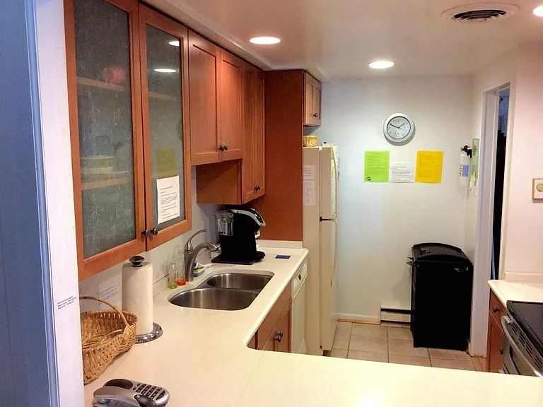 Kitchen with full appliances, dishware, and dishwasher.