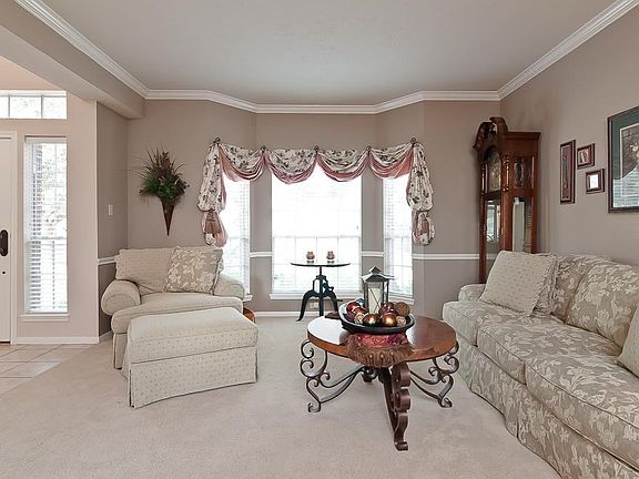 Just off the foyer is this beautiful formal living area complete with crown & chair rail moulding, n