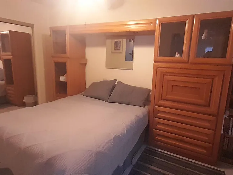 Queen bed, drop down desk, chair, bookcase with books and magazines on Tucson and AZ, smart tv, wifi internet, dresser, large closet, ceiling fan
