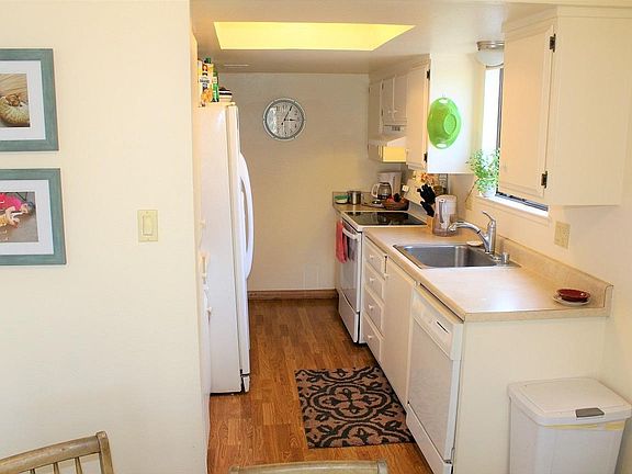 Kitchen flows from front door to Dining Area, overlooks parking lot.