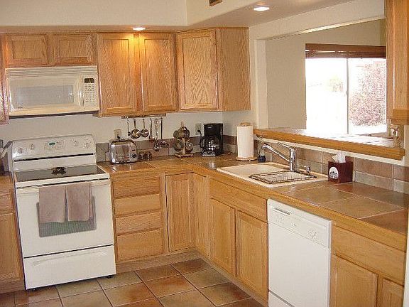 Kitchen with all appliances and 12" tile countertops and floor.