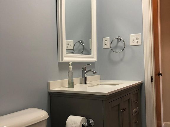 new vanity, mirror and lighting in bathroom