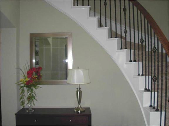 Curved stairwell takes you up to 4 more bedrooms, 2 full bathrooms and a large game room.