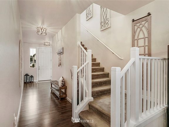This gorgeous home shines with laminate floors, soft inviting colors and elegant light fixtures