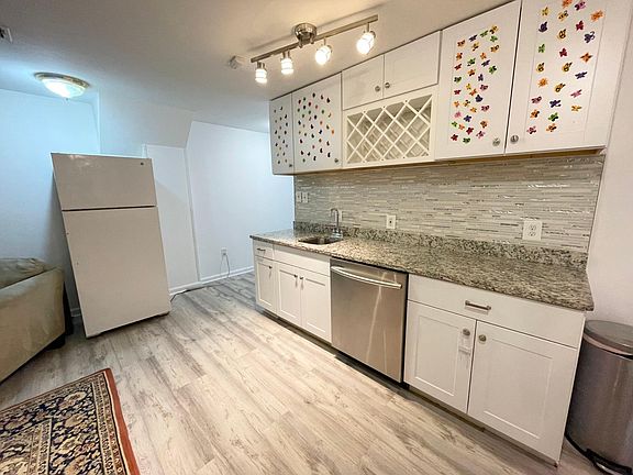 Beautiful Kitchenette area with Refrigerator, dishwasher, deep stainless steel sink; Landlord to provide new (2022) microwave/convection combo countertop oven.