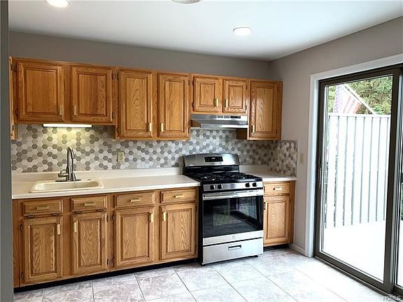 Nice clean kitchen with new appliances and slider to the balcony