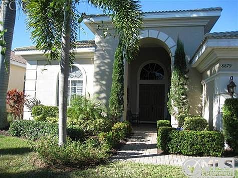 Elegant entrance with 8 foot doors and 16 foot ceiling height. Notice custom plantation shutters on 