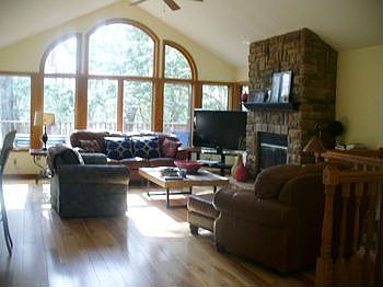 Nice open Living room with a gas fire place. The living room has windows all around so that you can enjoy the country living