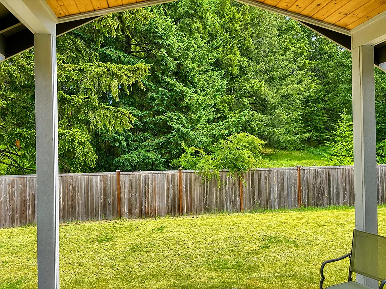 Covered back porch with fenced yard