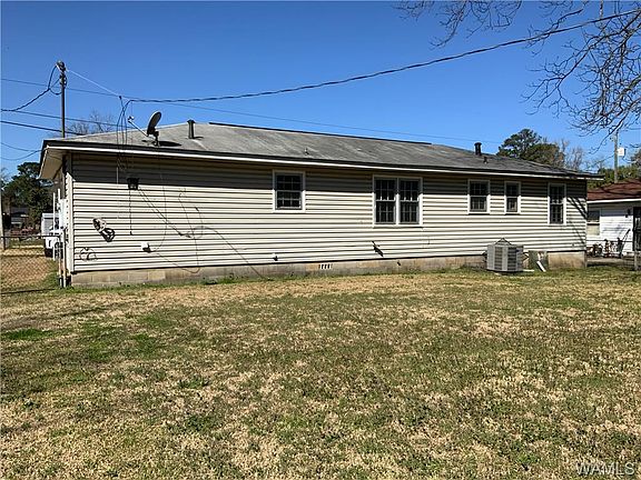 Image 3: Back of home with large yard.