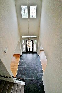 Foyer is flanked by arched entries to the formal Living and