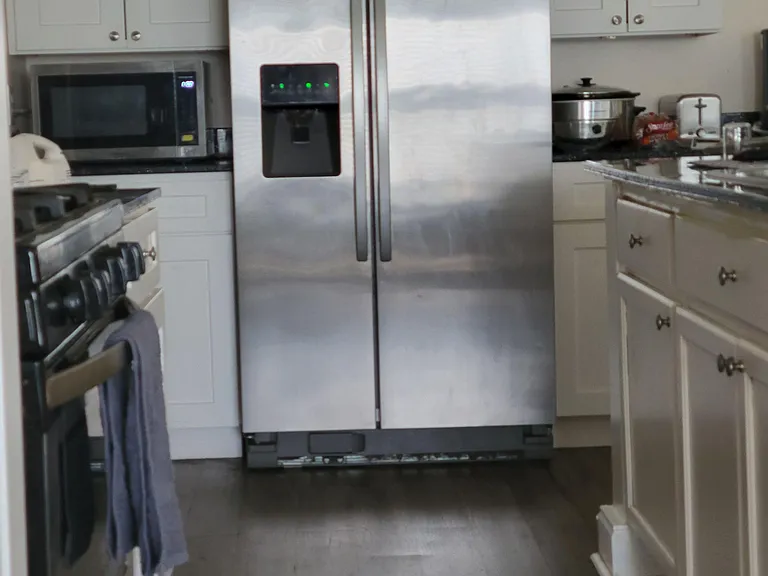 Kitchen with stainless side-by-side refrigerator, ample cabinetry, and generous counter space for everyday cooking.