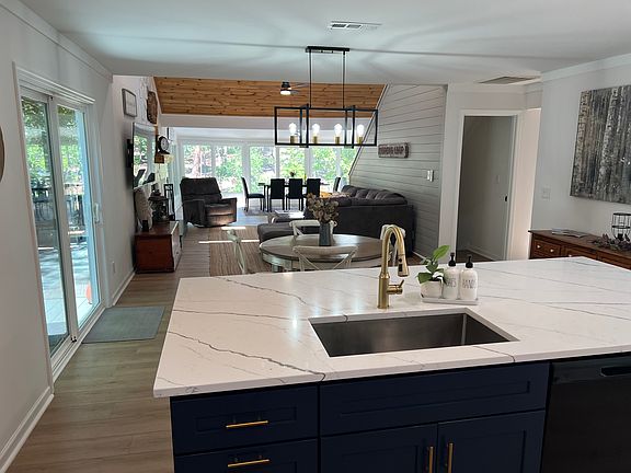 Open concept kitchen dining living room and sunroom