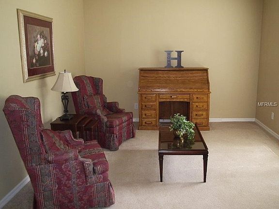 Formal living room with large window overlooking front lawn