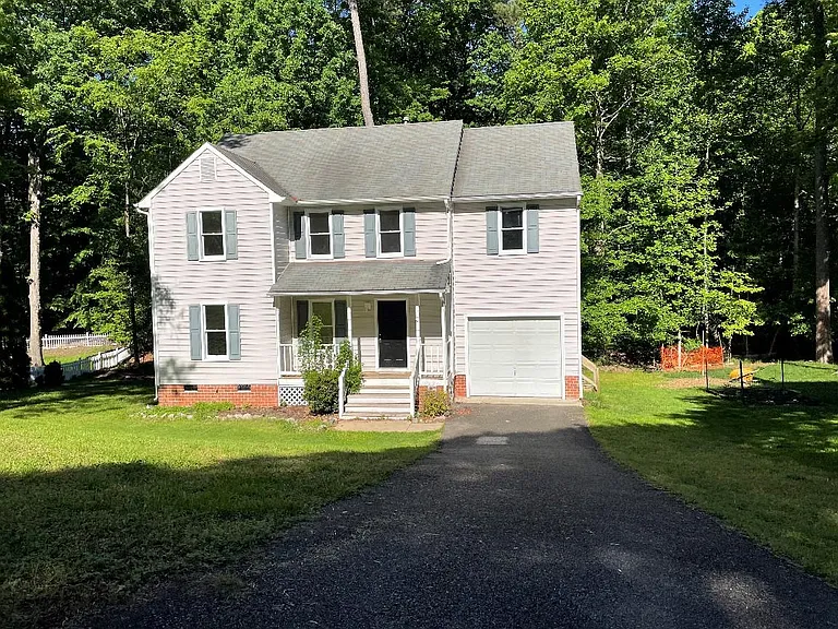 Spacious lot, paved driveway, front porch, garage