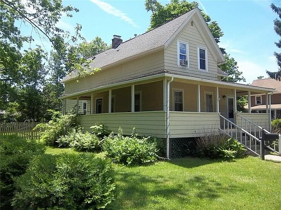 Spacious landscaped yard with mature plantings.